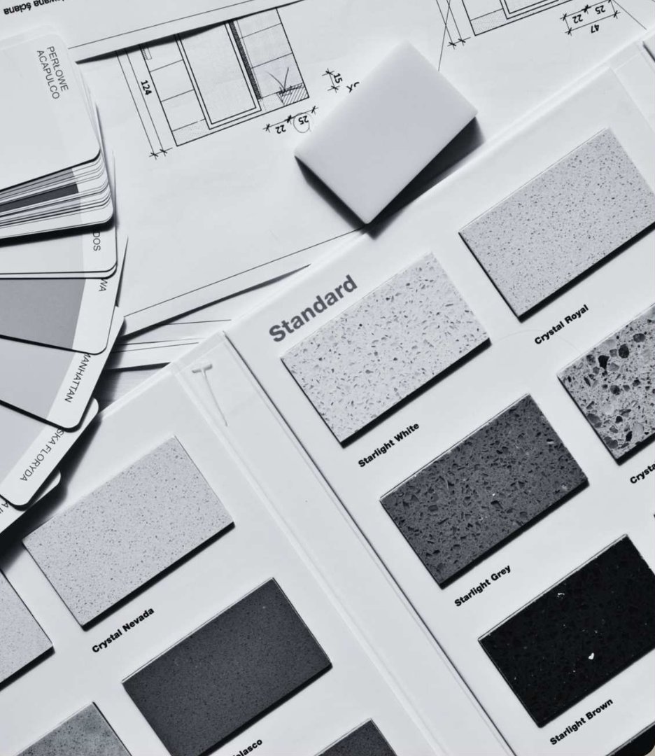 Material and finish samples laid out over architectural drawings